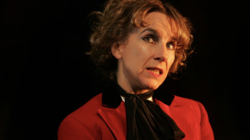 Stage portrait of woman in red jacket and black scarf, pensive expression, head tilted