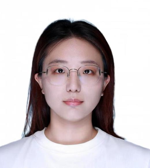 ID-style headshot of young woman wearing glasses and white shirt on plain white background