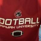Close-up of a maroon "Chapman University Football" jersey worn by a person, shown from the shoulders down.