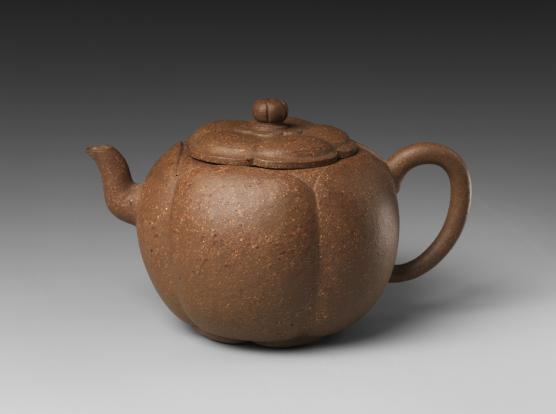 A brown teapot in the Shape of a Plum Blossom.
