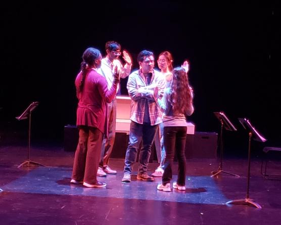 Five actors onstage with music stands 
