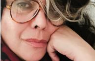 Woman with glasses staring into the camera