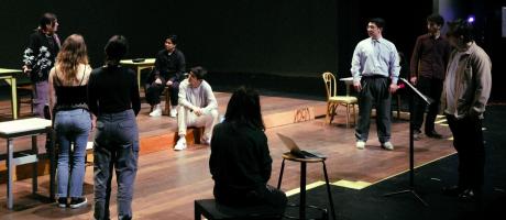 Group of actors onstage in rehearsal