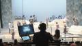 Stage manager in silhoutte during technical rehearsal with crew onstage.